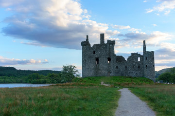Fototapeta na wymiar Kilchurn Castle , in the care of Historic Environment Scotland , is a ruined structure on a rocky peninsula at Loch Awe in twilight , Argyll and Bute, Scotland