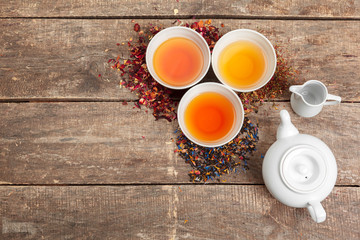 Creative layout made of cup of herbal tea on a wooden background