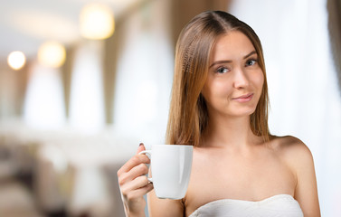Portrait of happy woman with mug in hands