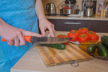 woman hands cutting vegetables on kitchen blackboard. Woman preparing vegetables