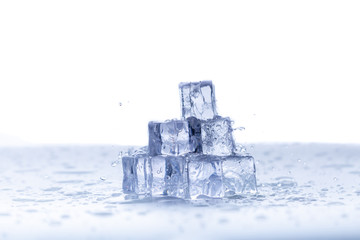 Fototapeta na wymiar Select Focus Pyramid ice cubes with pouring water and drops ,Ice melting. Cold concept 