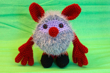 Amigurumi doll Brownie stands on a green background.