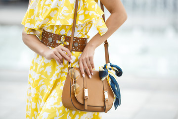 Women accessories closeup picture. Purse, sunglasses and the .kerchief. Brown handbag with fashion...