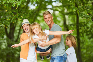 Fototapeta premium Girl is held by her parents