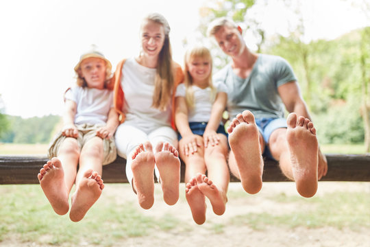 Family and children are sitting barefoot