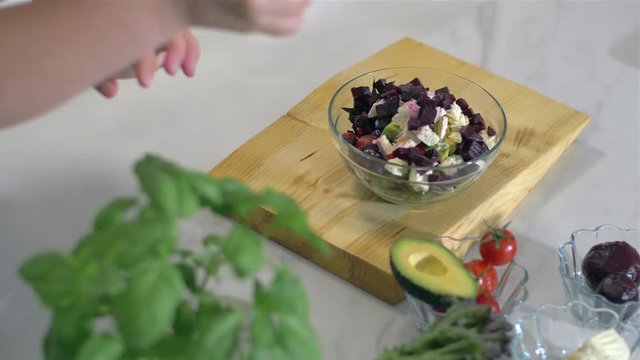 Decorate a fresh salad with basil
