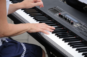Hands of a musician at the piano during a concert
