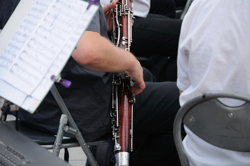 Hands of the musician on the bassoon during a concert of the symphony orchestra
