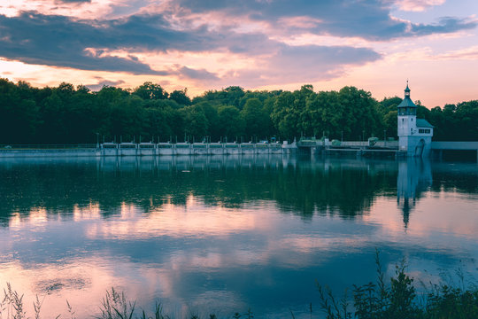 Image of reservoir lake with water reflections during sunset