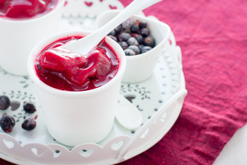 Blackcurrant sorbet in white cups, selective focus