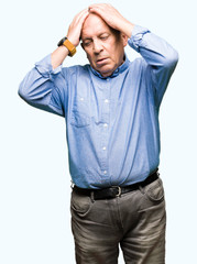 Fototapeta premium Handsome senior businesss man wearing elegant shirt suffering from headache desperate and stressed because pain and migraine. Hands on head.