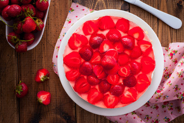 Cheesecake without baking with strawberries on a wooden table, top view, selective focus