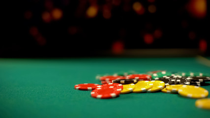 Poker chips lying on green table, poker and blackjack casino games, betting