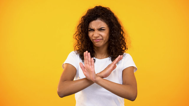 Dissatisfied Young Female With Crossed Arms Showing No Gesture On Camera, Ban