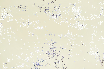 Yellow background with many small silver stars.