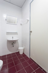 Mirror in white toilet room with red floor textile