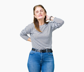 Fototapeta premium Middle age mature beautiful woman wearing stripes winter sweater over isolated background Suffering of neck ache injury, touching neck with hand, muscular pain