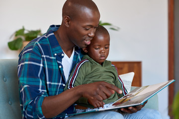 Loving father reading stories to kid