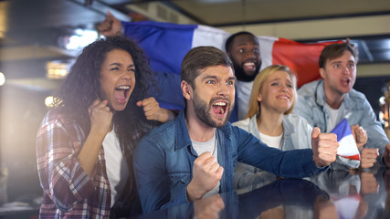 Happy football fans with French flag celebrating victory in tournament, patriots