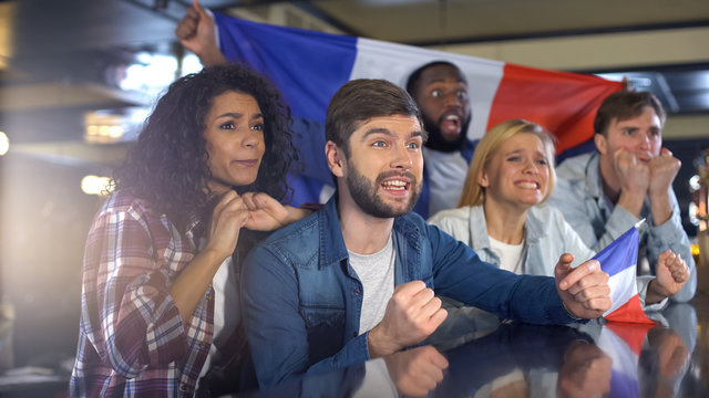 French sport supporters with flag cheering for national team in championship