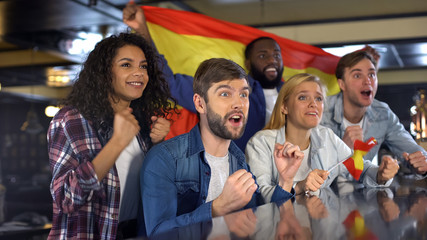 Sport fans with Spanish flag enjoying tournament, celebrating winning game