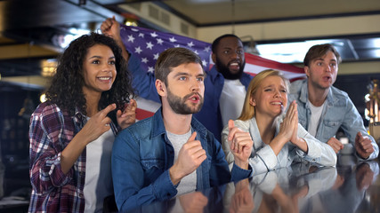 American sport fans supporting national team watching tournament in sport bar