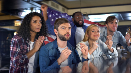 Nervous American fans watching sport competition supporting national team
