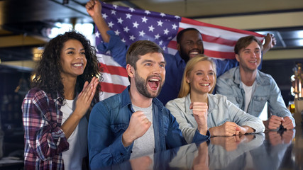 Happy sport fans holding flag of America, celebrating victory of national team - Powered by Adobe