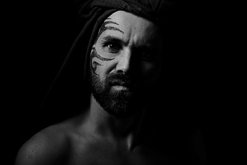tattoo on the face,  man with a tattoo,  brutal bearded guy, studio portrait of a man