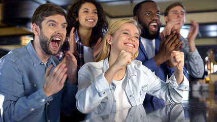 Excited sport fans celebrating team goal, clapping hands together, leisure