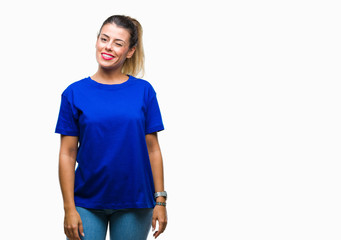 Young beautiful woman wearing casual blue t-shirt over isolated background winking looking at the...