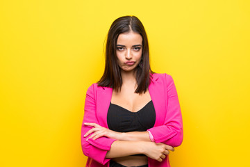 Obraz premium Young woman over isolated yellow background feeling upset