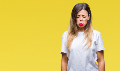 Obraz premium Young beautiful woman casual white t-shirt over isolated background depressed and worry for distress, crying angry and afraid. Sad expression.