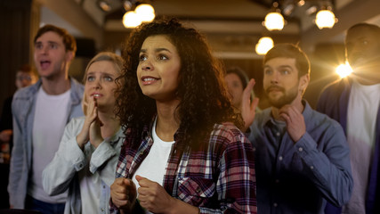 Nervous young people waiting for elections results, hoping for favorites victory