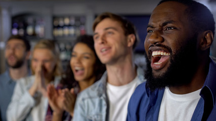 Young happy fans celebrating goal, rooting team victory, championship success