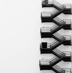 Metal fire escape on facade of old building in bangkok City - obrazy, fototapety, plakaty