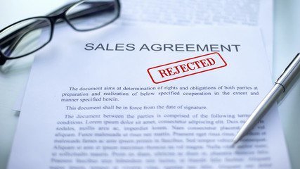 Sales agreement rejected, seal stamped on official document, business contract