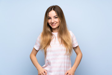 Fototapeta premium Young woman over isolated blue background laughing