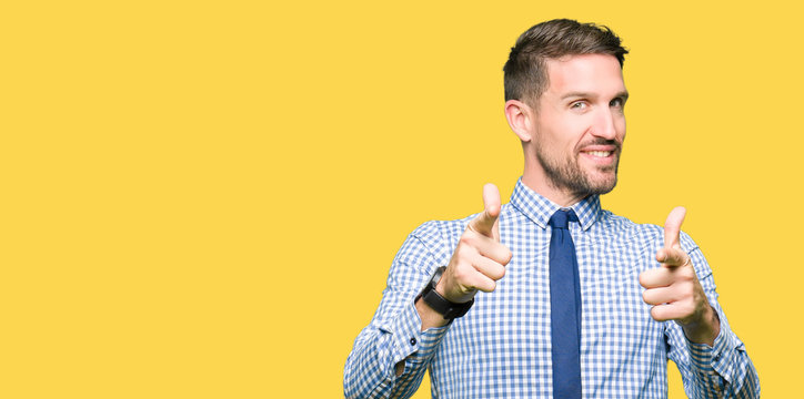 Handsome business man wearing tie pointing fingers to camera with happy and funny face. Good energy and vibes.