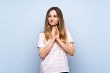 Young woman over isolated blue background scheming something