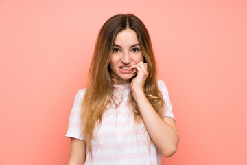 Young woman over isolated pink wall nervous and scared