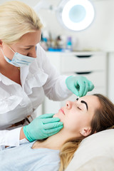 Beautician performing henna brows correction