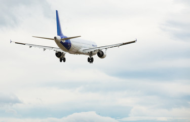 Naklejka na ściany i meble modern passenger plane lands at airport