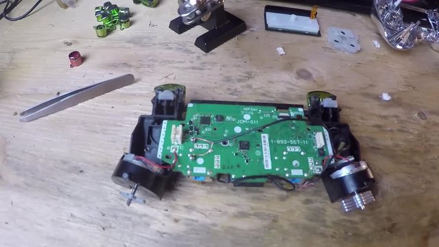 Fixing a circuit board inside of a video game controller.
