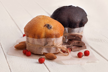 Chocolate muffin and nut muffin on wooden background. - 275647999