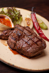 Well-done steak with suace and vagetables. Food photo for restaurant menu.