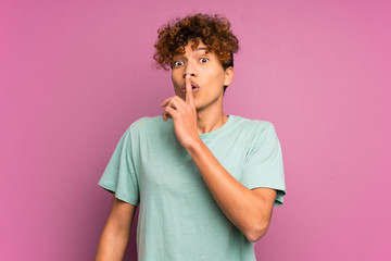 Young african american man over isolated purple wall doing silence gesture