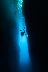 Obraz na płótnie Canvas Scuba divers swimming under water