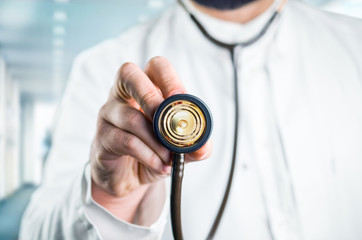 Male doctor with stethoscope in his hand