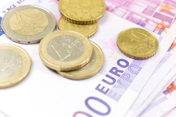 Close-up Stack of Euro banknotes and coins. 500 Euro banknotes. European currency money banknotes isolated on white backdrop. Perspective view closeup. Salary, savings, european union economic crisis 